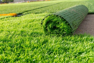 Artificial grass being laid out.