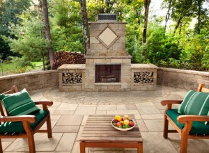 Backyard patio seating area with an outdoor fireplace.