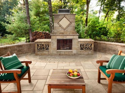 Backyard patio seating area with an outdoor fireplace.