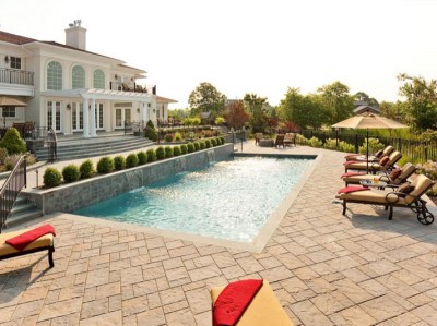 backyard landscape with a pool and patio set up