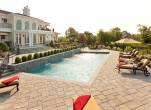 backyard landscape with a pool and patio set up