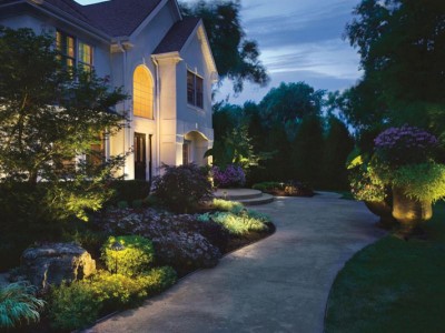 Home with outdoor lighting along a pathway. Home with outdoor lighting along a pathway.