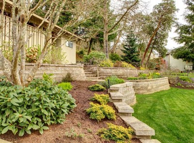 Retaining wall in a beautifully-landscaped backyard space.