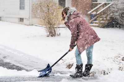 Woman shoveling snow.