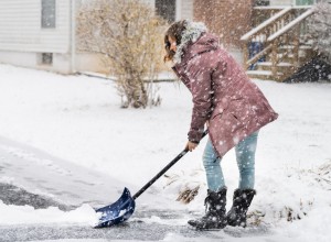 Woman shoveling snow.